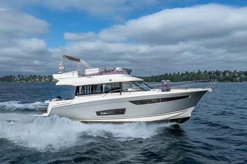  Yacht Photos Pics 2016 Jeanneau Velasco 43F yacht cruising on open water under a cloudy sky.