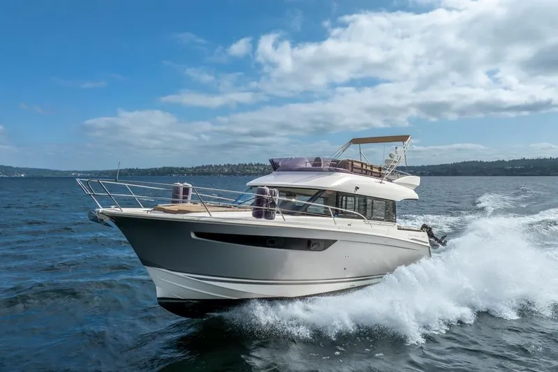  Yacht Photos Pics 2016 Jeanneau Velasco 43F yacht cruising on open water under a clear blue sky.