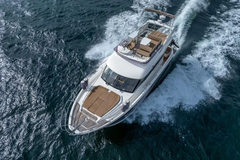  Yacht Photos Pics 2016 Jeanneau Velasco 43F yacht cruising on open water, aerial view.