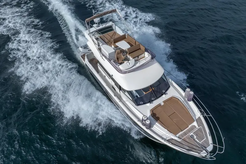  Yacht Photos Pics 2016 Jeanneau Velasco 43F yacht cruising on open water, aerial view.