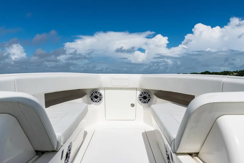  Yacht Photos Pics 2023 SeaVee 340Z boat interior with white seating and blue sky background.