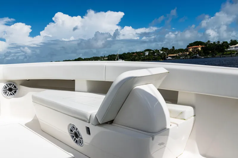  Yacht Photos Pics 2023 SeaVee 340Z boat interior with white seating and speakers, under a blue sky.