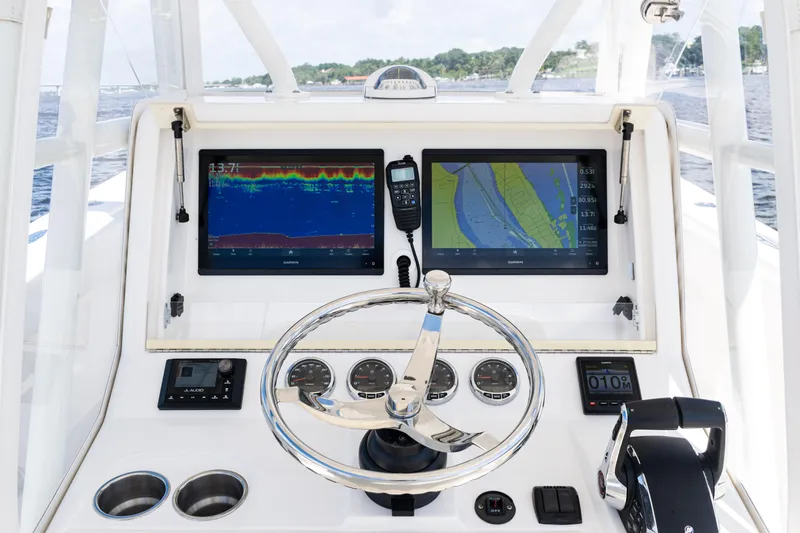  Yacht Photos Pics 2023 SeaVee 340Z boat dashboard with navigation screens and steering wheel.