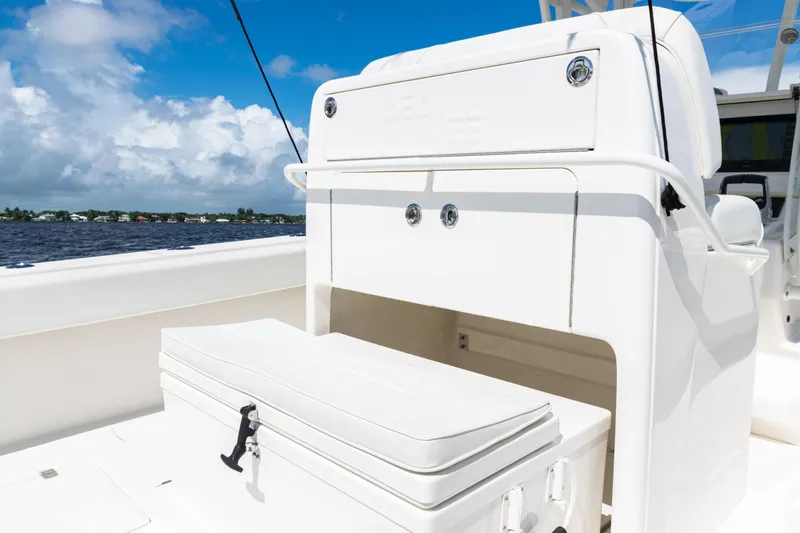  Yacht Photos Pics 2023 SeaVee 340Z boat interior with storage compartment and cooler, under a clear blue sky.