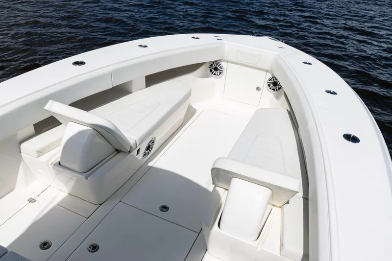  Yacht Photos Pics 2023 SeaVee 340Z boat interior with white seating and speakers, on calm water.