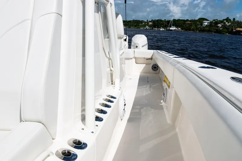  Yacht Photos Pics 2023 SeaVee 340Z boat interior with white seating and cup holders, on a sunny day.