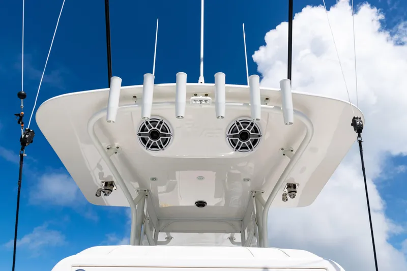  Yacht Photos Pics 2023 SeaVee 340Z boat top view with rod holders and speakers against blue sky.