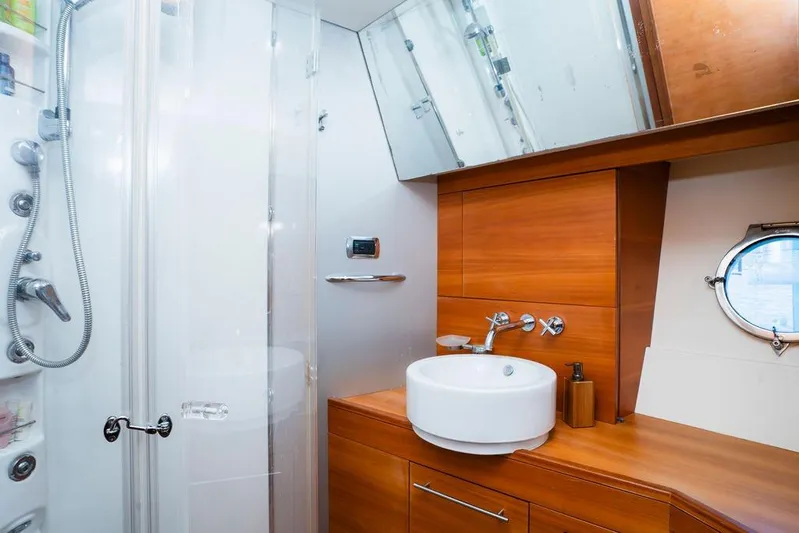 Voluptas Yacht Photos Pics Luxurious bathroom in 2006 Aicon 64 yacht with modern fixtures and wooden cabinetry.