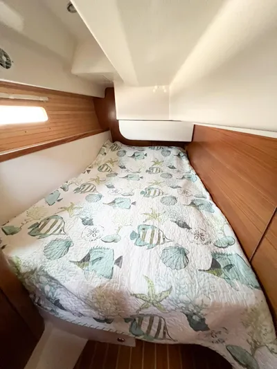 Chloe Brighid Yacht Photos Pics Cozy cabin interior of 2019 Catalina 425 sailboat with patterned bedding.