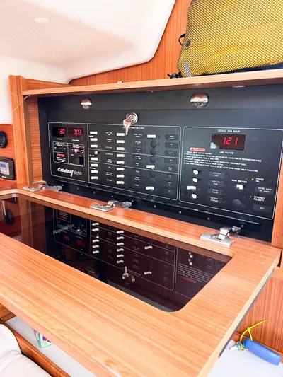 Chloe Brighid Yacht Photos Pics Electrical control panel inside a 2019 Catalina 425 yacht, featuring various switches and displays.