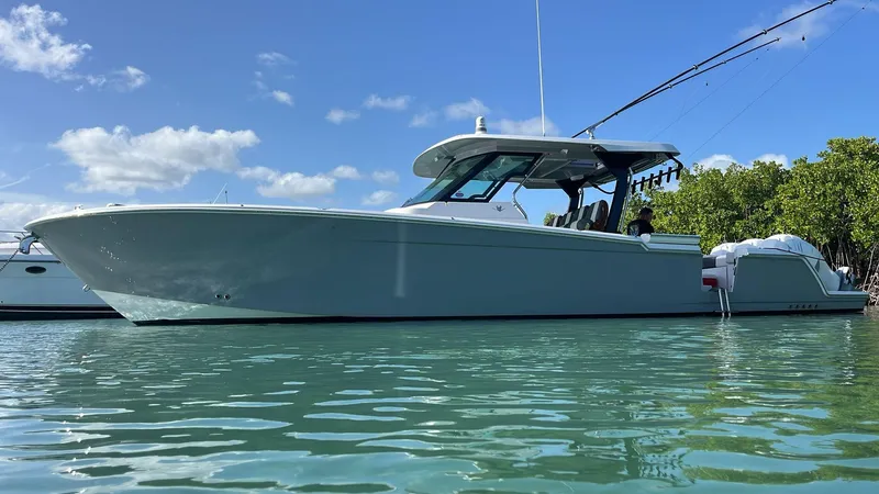  Yacht Photos Pics 2022 Bertram 39 CC boat on calm water under blue sky.