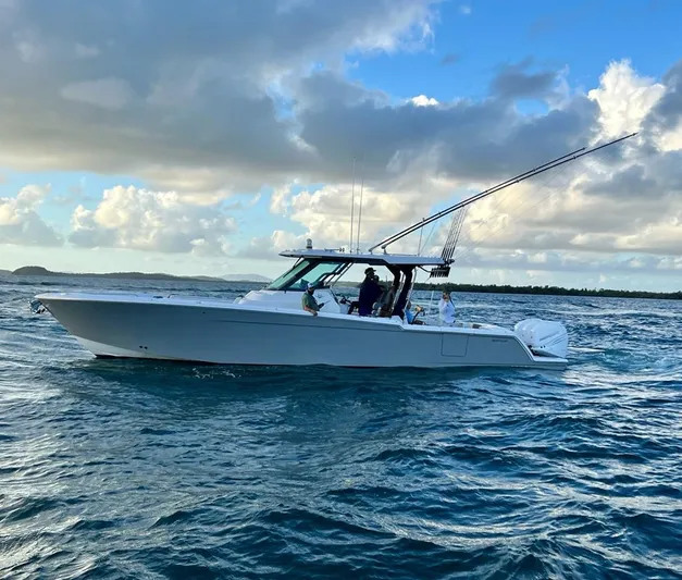  Yacht Photos Pics 2022 Bertram 39 CC boat cruising on open water under a cloudy sky.