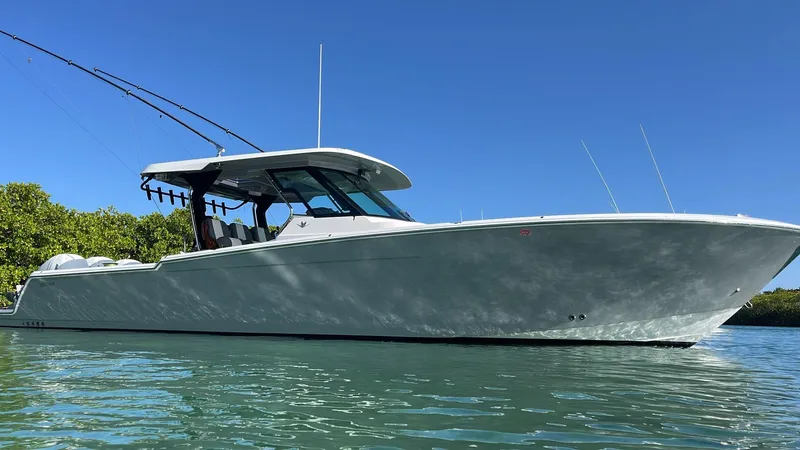  Yacht Photos Pics 2022 Bertram 39 CC boat on calm water under clear blue sky.