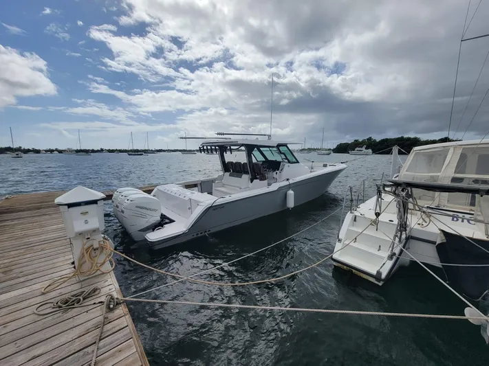  Yacht Photos Pics 2022 Bertram 39 CC boat docked at marina under cloudy sky.