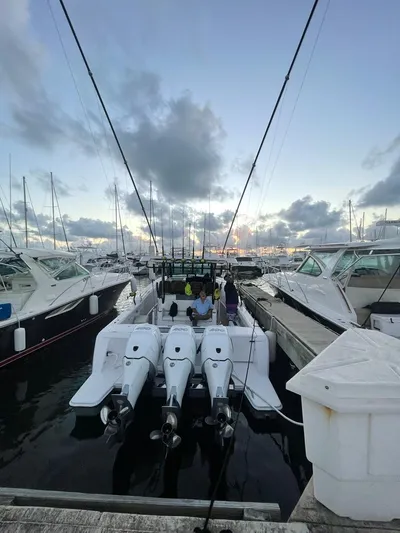  Yacht Photos Pics 2022 Bertram 39 CC boat docked with triple outboard engines at marina.