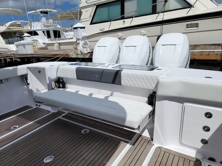  Yacht Photos Pics 2022 Bertram 39 CC boat with sleek seating and powerful engines at a marina.