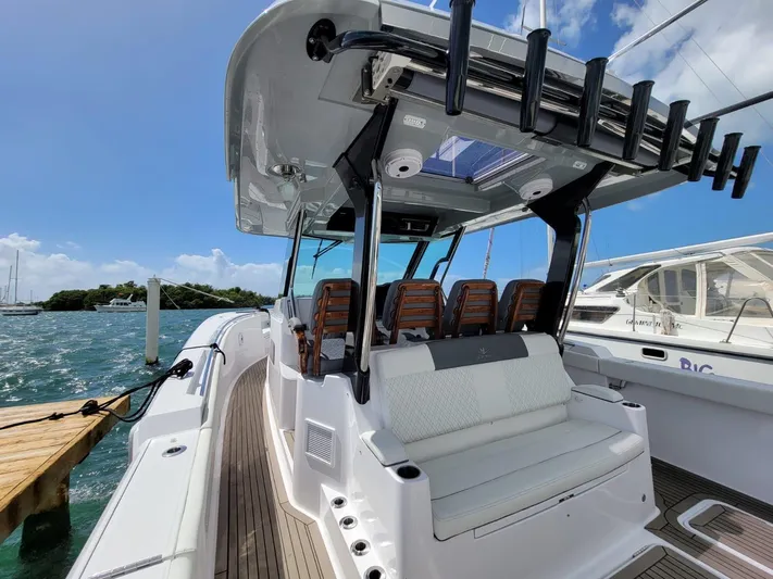  Yacht Photos Pics 2022 Bertram 39 CC boat with sleek seating and rod holders, docked by the water.