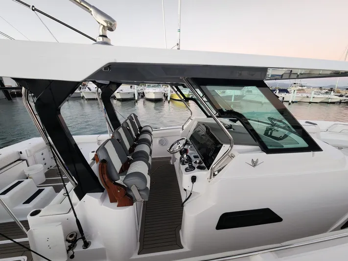  Yacht Photos Pics 2022 Bertram 39 CC boat interior with modern helm and seating at marina.