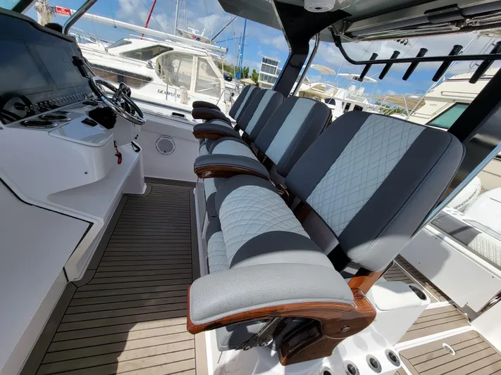  Yacht Photos Pics 2022 Bertram 39 CC boat interior with luxury seating and modern dashboard.