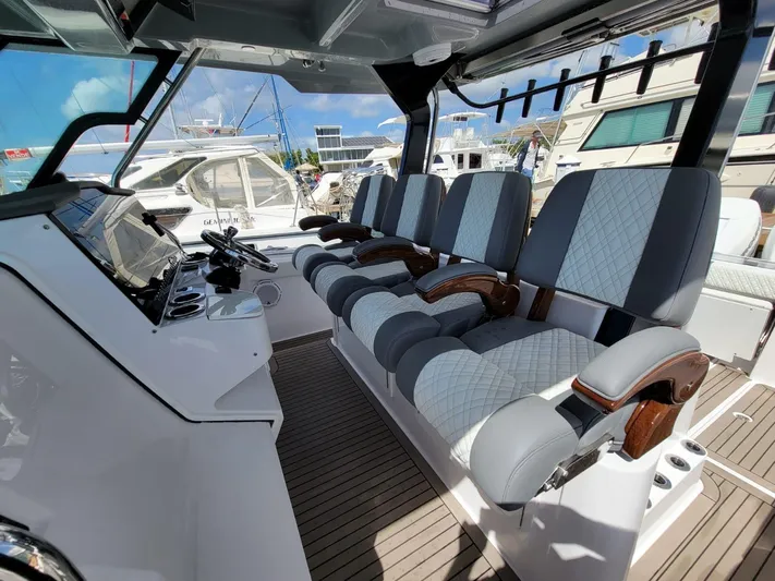  Yacht Photos Pics 2022 Bertram 39 CC boat interior with luxurious seating and modern dashboard.