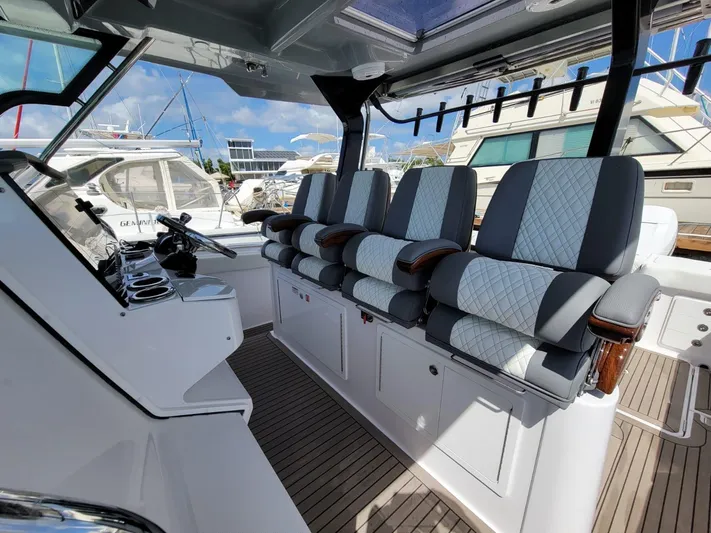  Yacht Photos Pics 2022 Bertram 39 CC boat interior with luxurious seating and modern helm.