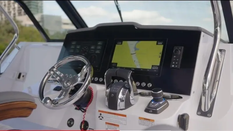  Yacht Photos Pics 2022 Bertram 39 CC boat dashboard with steering wheel and navigation display.