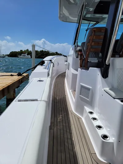  Yacht Photos Pics 2022 Bertram 39 CC boat docked, showcasing sleek design and spacious deck.