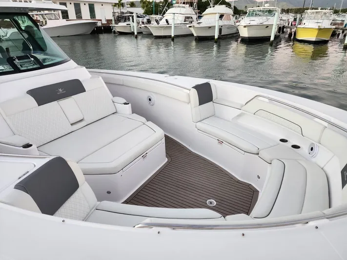  Yacht Photos Pics Luxurious seating area on a 2022 Bertram 39 CC boat docked at a marina.