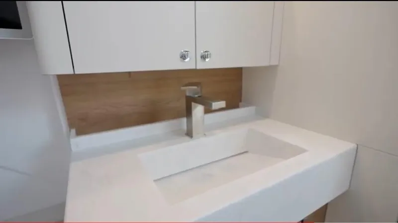  Yacht Photos Pics Modern bathroom sink in 2022 Bertram 39 CC yacht, featuring sleek design and cabinetry.