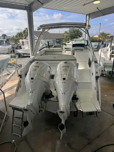  Yacht Photos Pics 2024 Cobalt 30SC Outboard boat with twin engines in a showroom.
