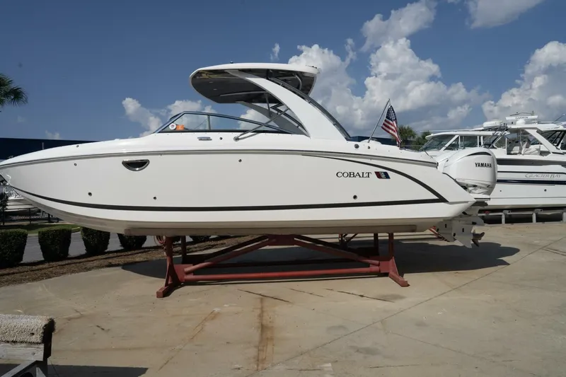  Yacht Photos Pics 2024 Cobalt 30SC Outboard boat on display under a clear blue sky.