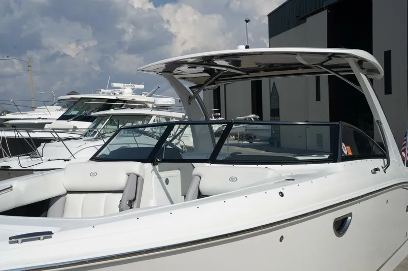  Yacht Photos Pics 2024 Cobalt 30SC Outboard boat docked, showcasing sleek design and modern features.