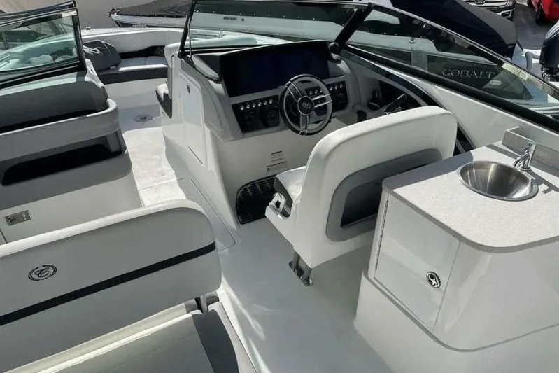 Yacht Photos Pics 2024 Cobalt 30SC Outboard boat interior with helm, seating, and sink.