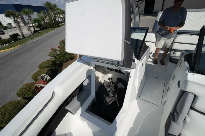  Yacht Photos Pics 2024 Cobalt 30SC Outboard boat interior with open storage compartment and seating.