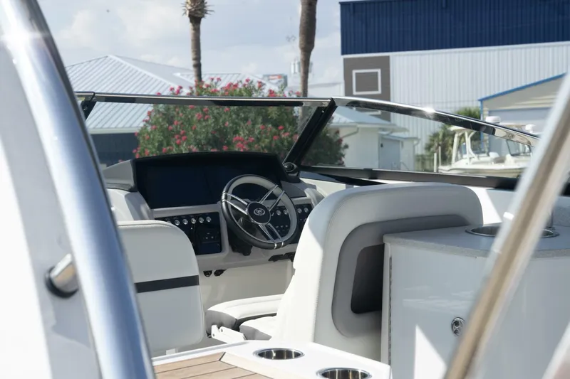  Yacht Photos Pics 2024 Cobalt 30SC Outboard boat interior with steering wheel and dashboard.