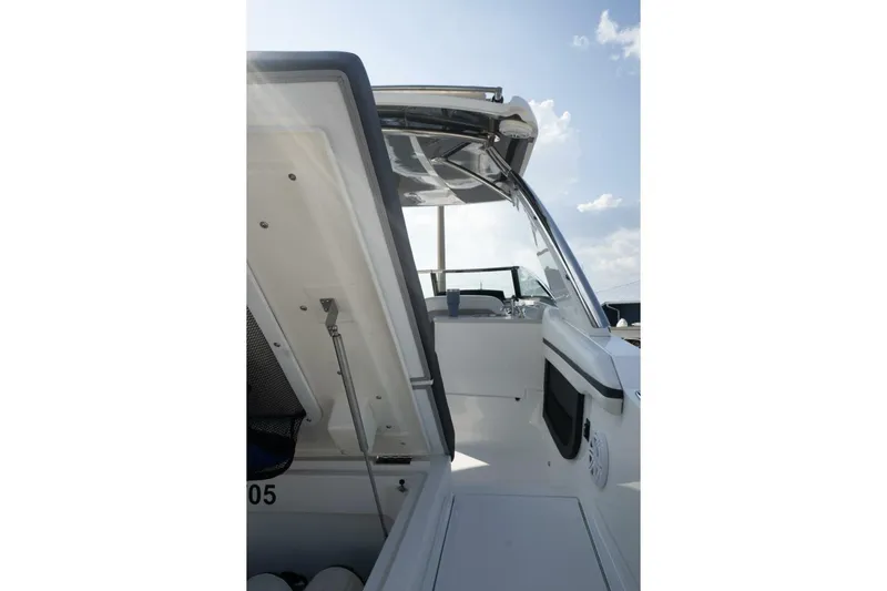  Yacht Photos Pics 2024 Cobalt 30SC Outboard boat interior with open storage compartment and seating area.