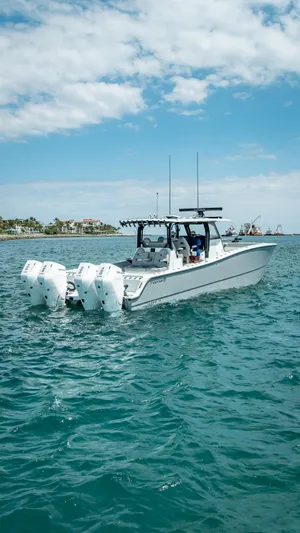  Yacht Photos Pics 2024 Freeman 43 boat on open water with four engines, under a partly cloudy sky.