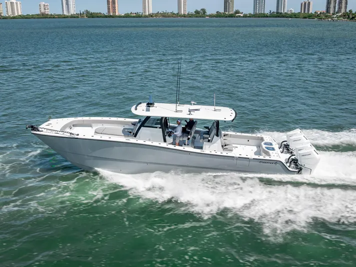  Yacht Photos Pics 2024 Freeman 43 boat cruising on open water with city skyline in background.