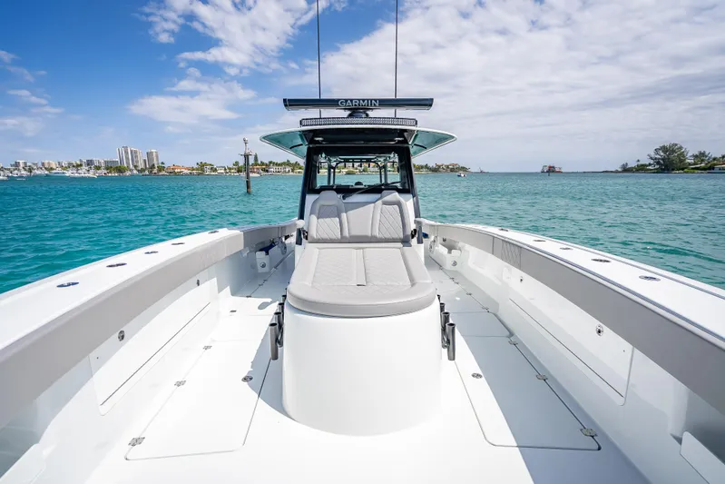  Yacht Photos Pics 2024 Freeman 43 boat on clear blue water with city skyline in background.