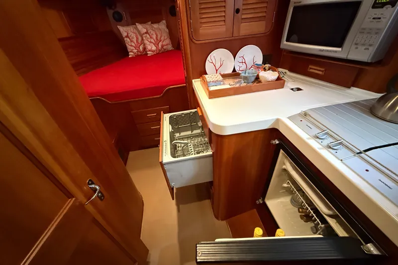 Brass Ring Yacht Photos Pics Hinckley Talaria 40 yacht interior, featuring a cozy cabin and modern kitchen amenities.