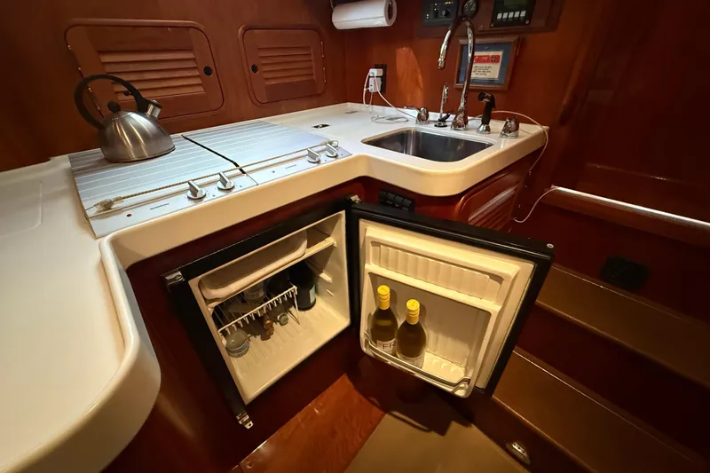 Brass Ring Yacht Photos Pics 2003 Hinckley Talaria 40 yacht kitchen with sink, stove, and open fridge.