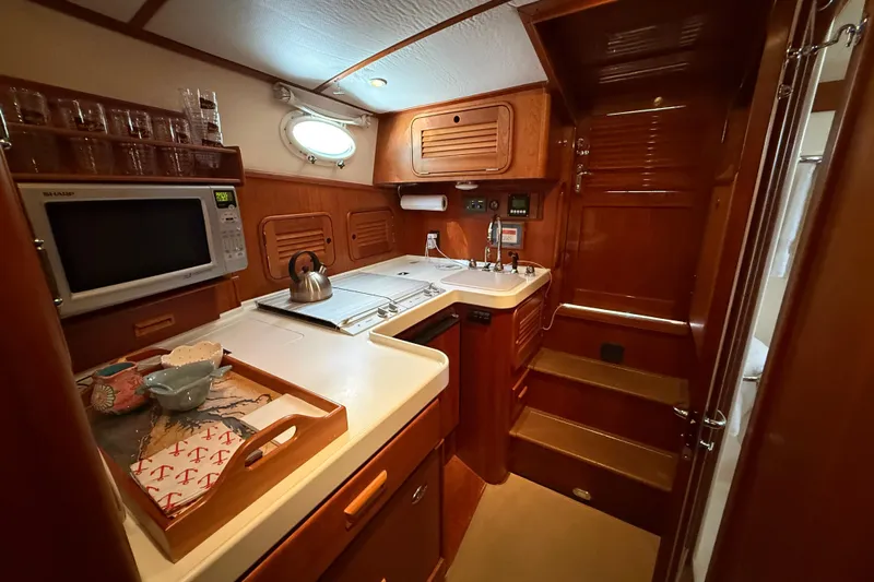 Brass Ring Yacht Photos Pics Luxurious 2003 Hinckley Talaria 40 yacht kitchen with wood cabinetry and modern appliances.