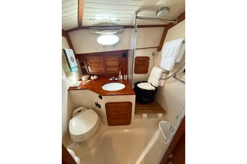 Brass Ring Yacht Photos Pics Luxurious 2003 Hinckley Talaria 40 yacht bathroom with wooden accents and modern amenities.