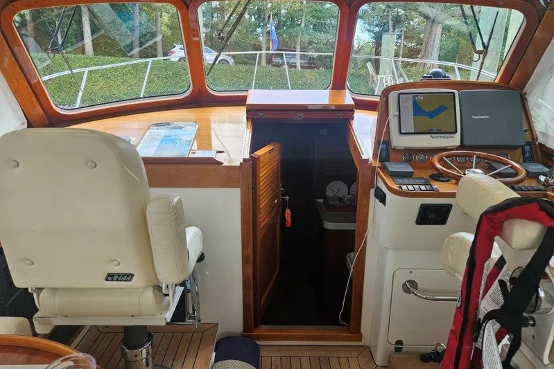 Brass Ring Yacht Photos Pics Interior of 2003 Hinckley Talaria 40 boat with navigation equipment and seating.