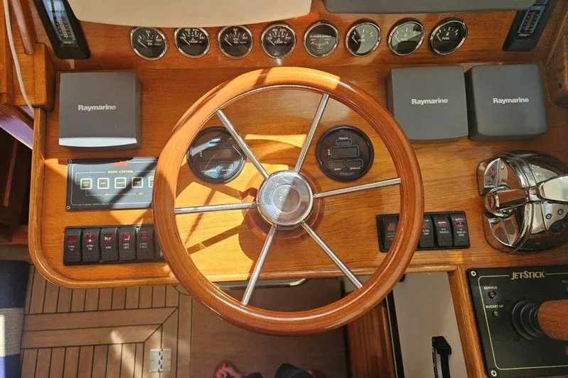 Brass Ring Yacht Photos Pics Helm of 2003 Hinckley Talaria 40 with wooden steering wheel and Raymarine electronics.