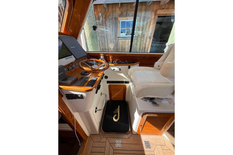 Brass Ring Yacht Photos Pics 2003 Hinckley Talaria 40 helm with wooden dashboard and leather seating.