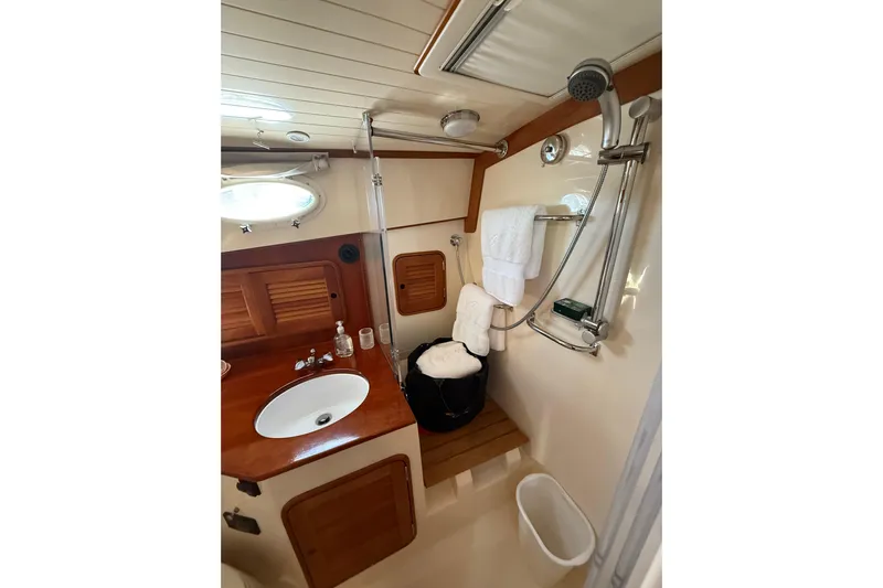 Brass Ring Yacht Photos Pics Luxurious bathroom interior of 2003 Hinckley Talaria 40 yacht with wooden accents.