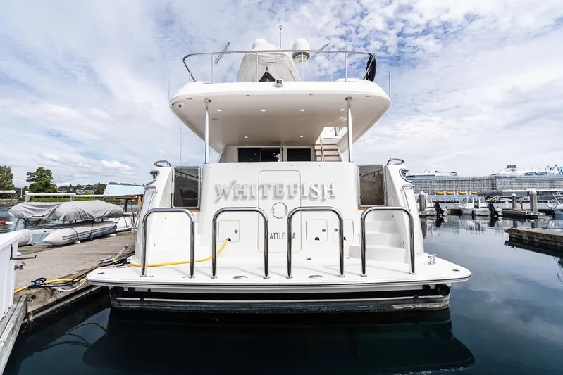 Whitefish Yacht Photos Pics 2013 Ocean Alexander 72 Pilothouse yacht docked at marina under cloudy sky.