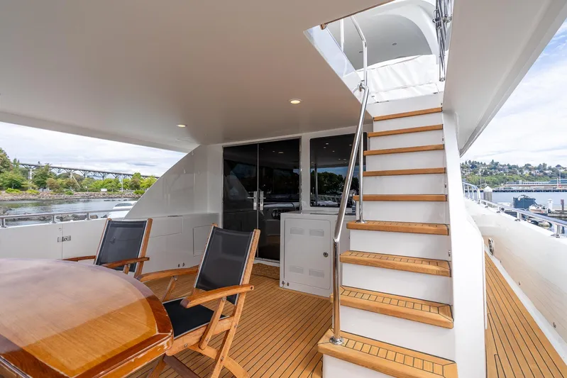 Whitefish Yacht Photos Pics Luxurious 2013 Ocean Alexander 72 Pilothouse yacht deck with wooden stairs and seating area.