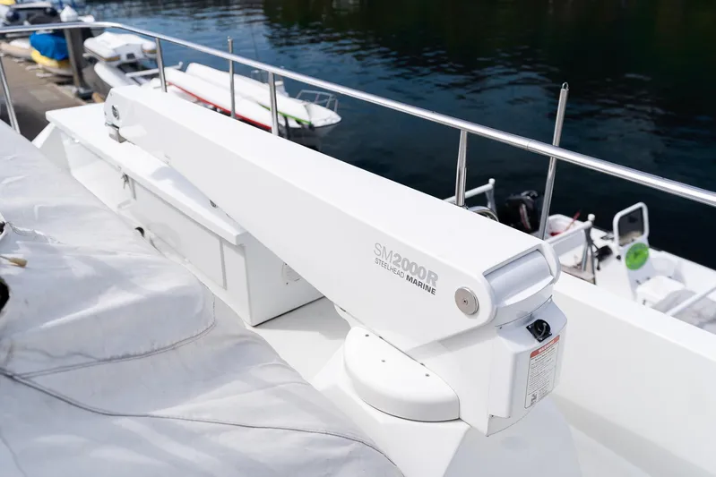 Whitefish Yacht Photos Pics Crane on 2013 Ocean Alexander 72 Pilothouse yacht, docked with boats in background.